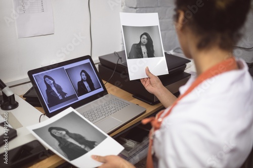 Female photographer developing photos photo