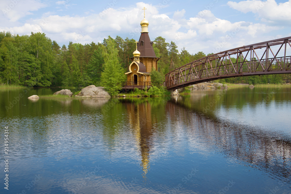 View of the Church of the Apostle Andrew the First-Called on the Vuoksa River on a sunny June afternoon. Vasilyevo, Leningrad Region. Russia
