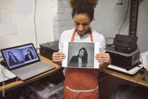 Female photographer showing photos in photo studio