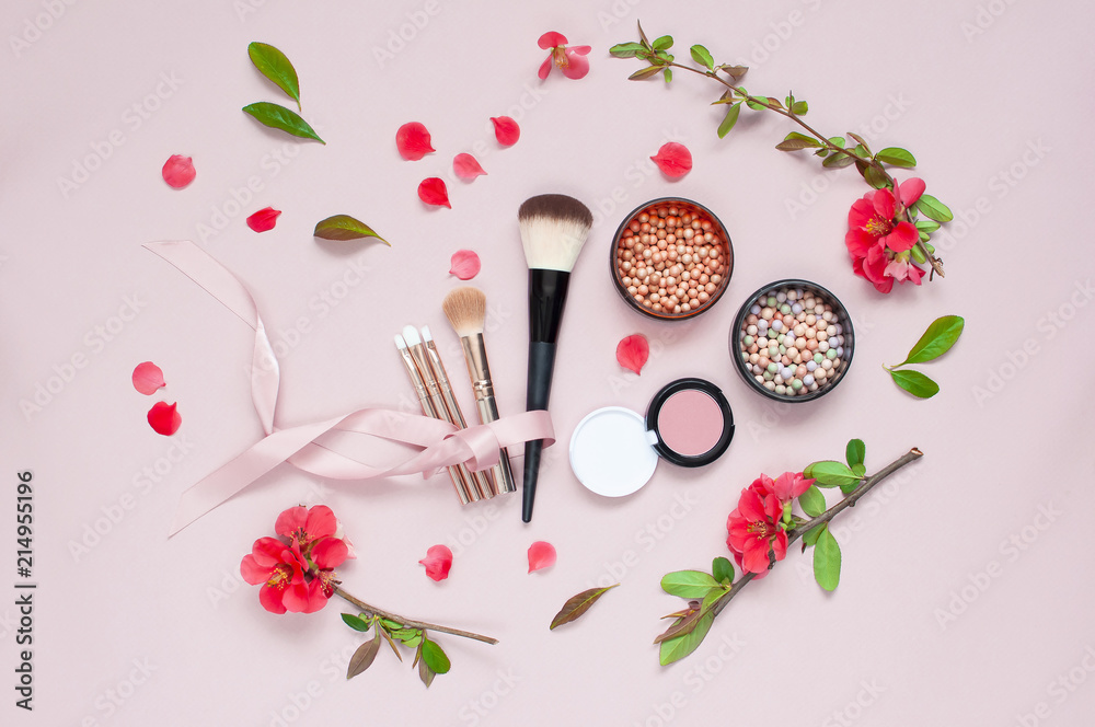 Various cosmetic products for make-up with red flowers on a pink background with copy space. Makeup Accessories Top view Flat Lay. Powder Rouge Eyeshadow Corrector Brushes Mascara Various cosmetic products for make-up with red flowers on a pink background with copy space. Makeup Accessories Top view Flat Lay. Powder Rouge Eyeshadow Corrector Brushes Mascara
