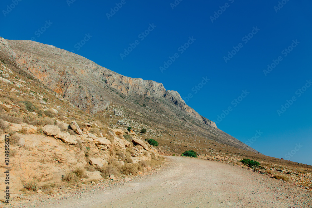 Idylic west Crete landscape with goats countryside road in summertime season, Greece