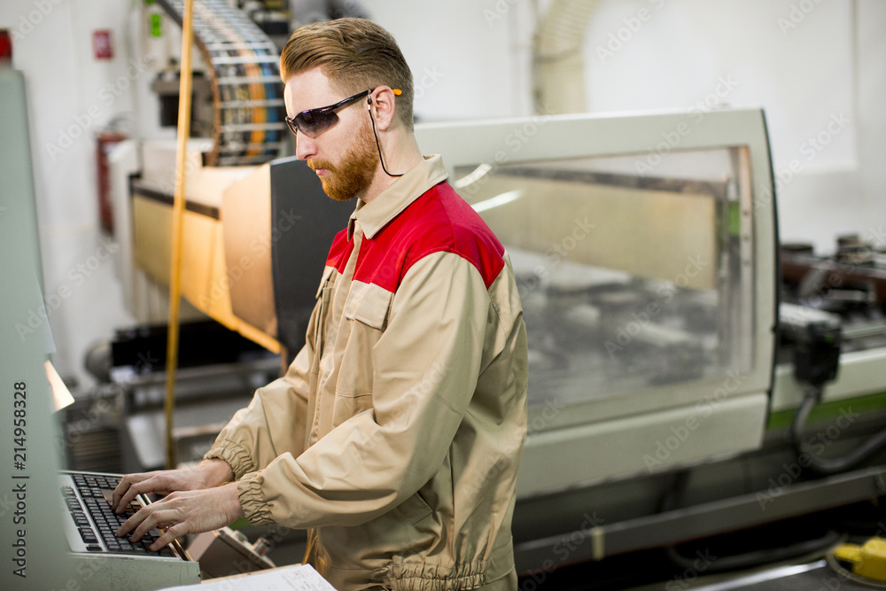 Young man working in the factory Young man working in the factory