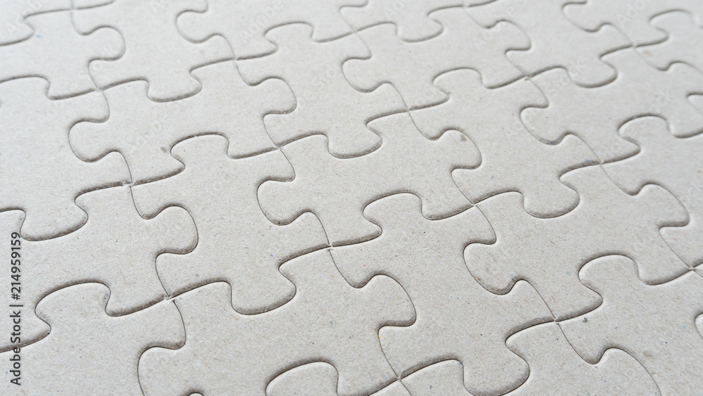 Hand put missing jigsaw puzzle into the paper board