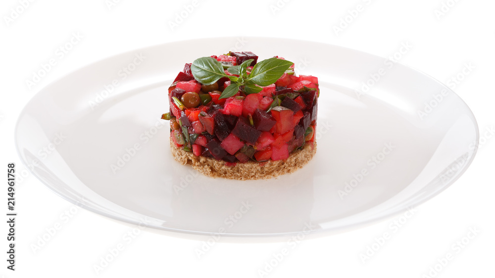 Salad Vinaigrette served on a slice of rye bread, decorated with fresh Basil. Isolated on white background.