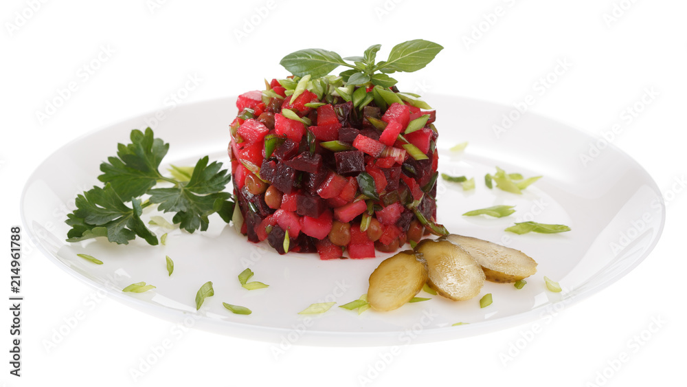 Vinaigrette salad is served on a plate, decorated with fresh Basil, pickles and green parsley. Isolated on white background. Vinaigrette salad is served on a plate, decorated with fresh Basil, pickles and green parsley. Isolated on white background.