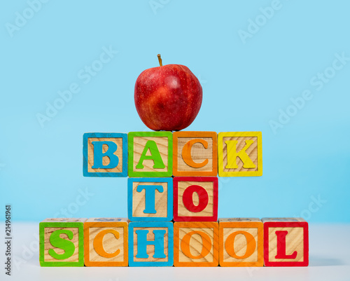 Back to School spelled out in wooden blocks with apple