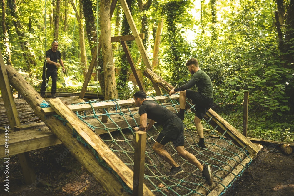 Fit mens training over obstacle course Fit mens training over obstacle course