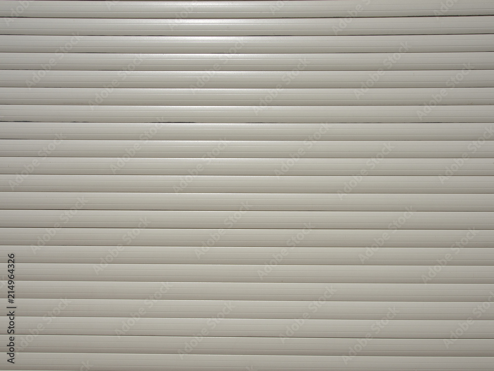 Fragment of electric blinds of light grey color Fragment of electric blinds of light grey color