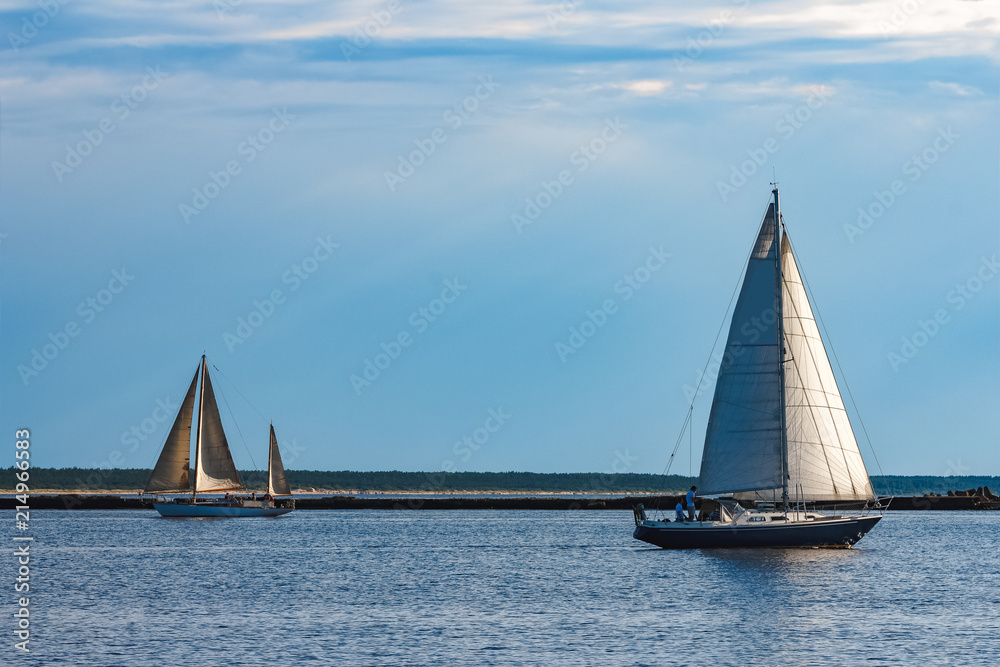 Fototapeta premium Blue sailboat at river