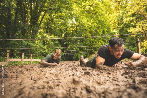 Men training under obstacle course photo