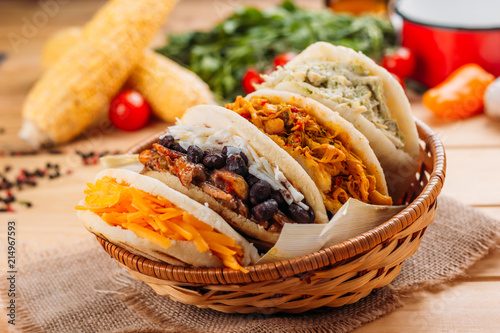 Combination of the typical South American Arepas in a woven basket photo