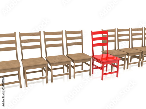 Wooden chairs in row with one red out