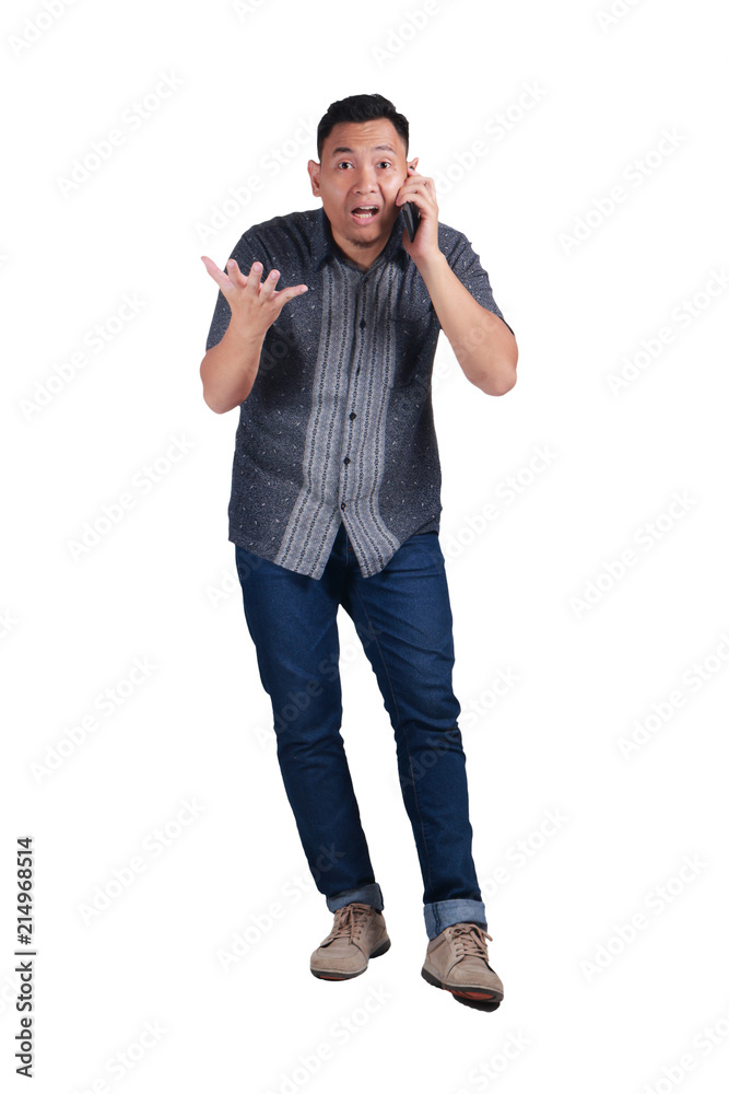 Young Man Talking on Phone, Shocked Worried Expression Young Man Talking on Phone, Shocked Worried Expression