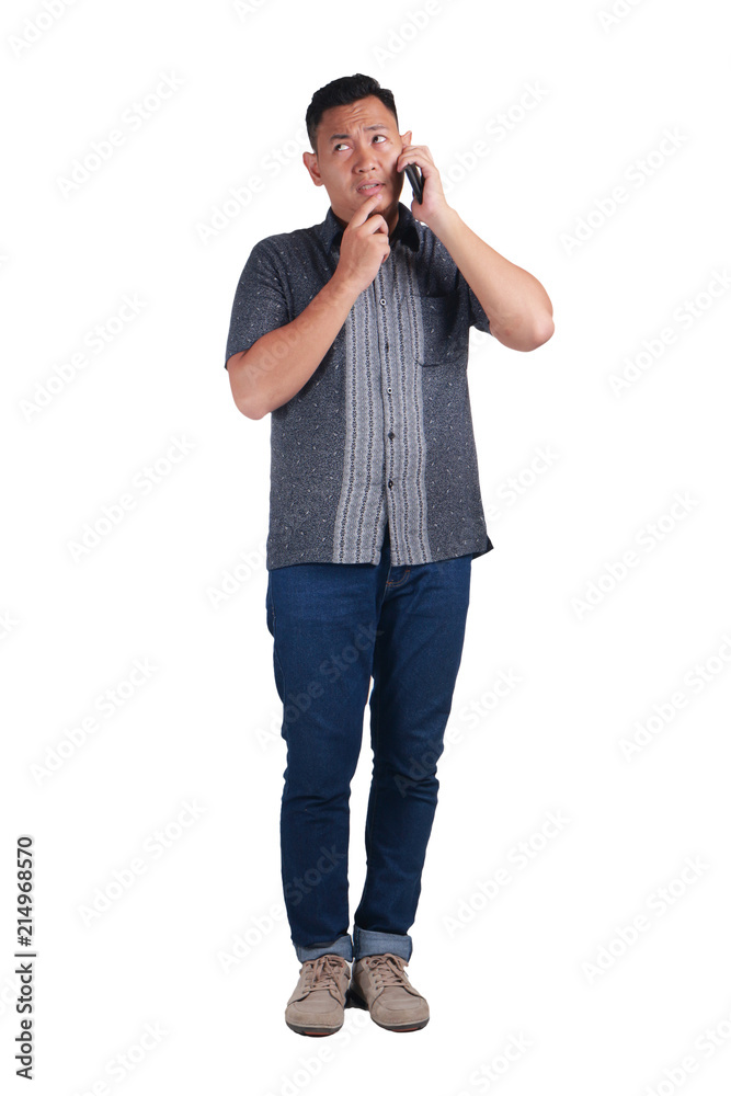 Young Man Talking on Phone, Thinking Expression Young Man Talking on Phone, Thinking Expression