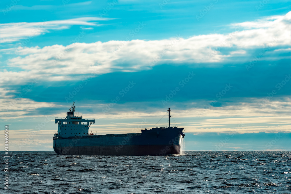 Obraz premium Blue cargo ship underway