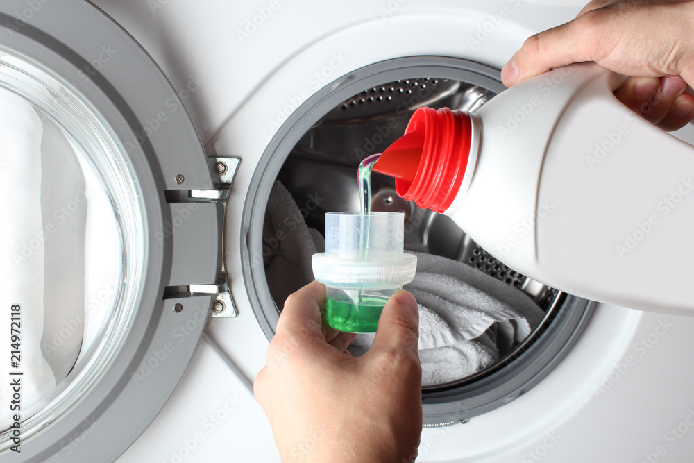 liquid detergent bottle pour washing machine Stock Photo | Adobe Stock