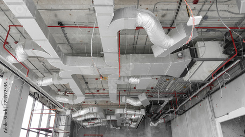 Air condition and hvac system installation under bareskin ceiling before interior finishing.