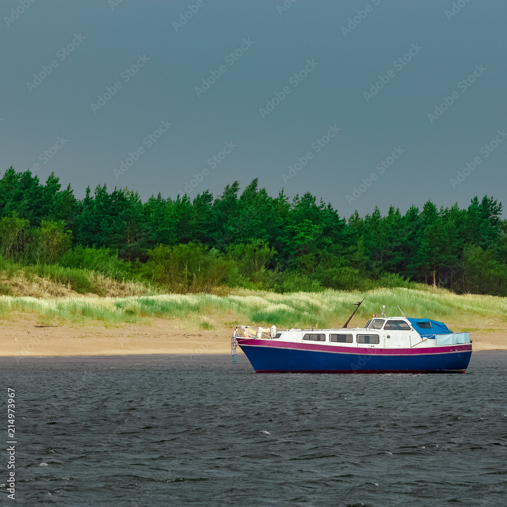 Obraz premium Small blue passenger ship