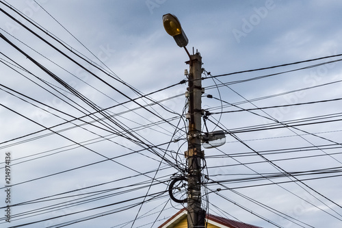 A lot of wires on the lamp post. A tangle of wires, a mess in electricity. Russia photo