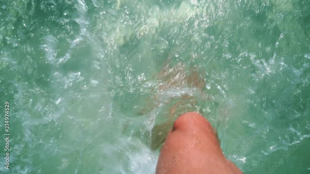 Walking through a shallow sandy water at the beach Walking through a shallow sandy water at the beach