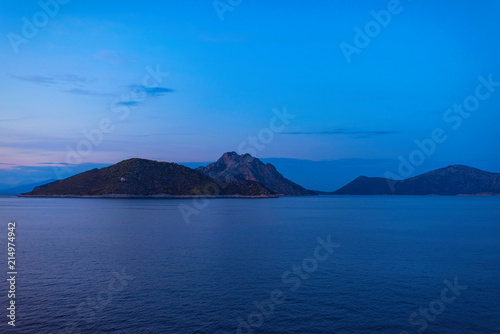 View of the Greek island of Atokos from the ferry at sunset. Greek islands in the Ionian Sea