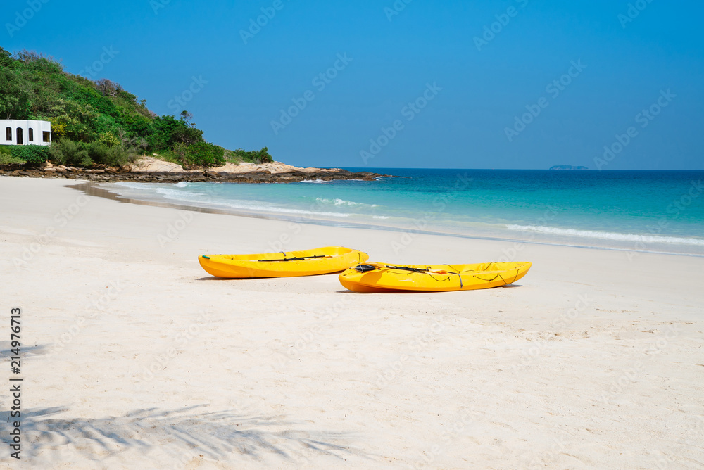 Two yellow kayaks on the beach on sunny day in summerTwo yellow kayaks on the beach on sunny day in summer Two yellow kayaks on the beach on sunny day in summerTwo yellow kayaks on the beach on sunny day in summer
