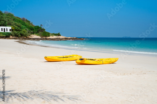 Two yellow kayaks on the beach on sunny day in summerTwo yellow kayaks on the beach on sunny day in summer