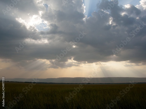 Rays of sunlight through cloud over plains of Africa
