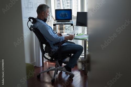 Man preparing architectural design on laptop photo