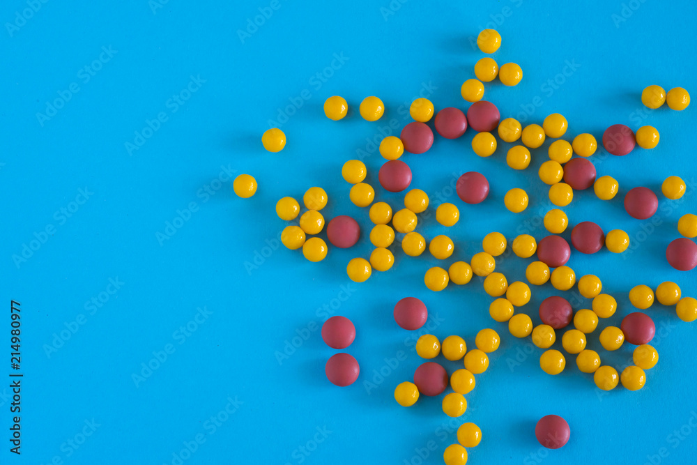 Assorted pharmaceutical medicine pills, tablets and capsules on blue background. Copy space for text. Medicine. top view Assorted pharmaceutical medicine pills, tablets and capsules on blue background. Copy space for text. Medicine. top view
