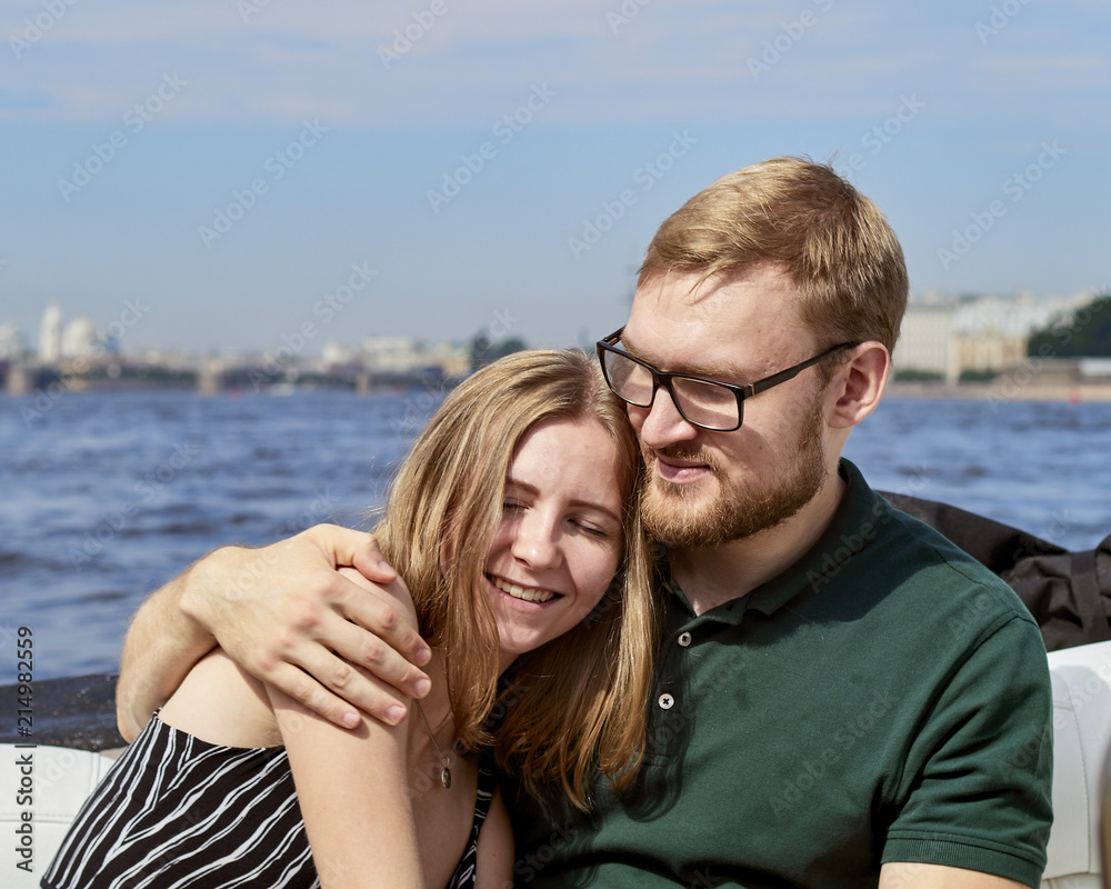 A young couple is traveling on a speedboat.
