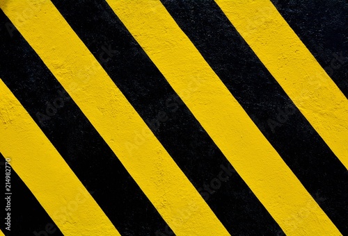 Yellow and black stripes on the concrete surface - background © sema_srinouljan