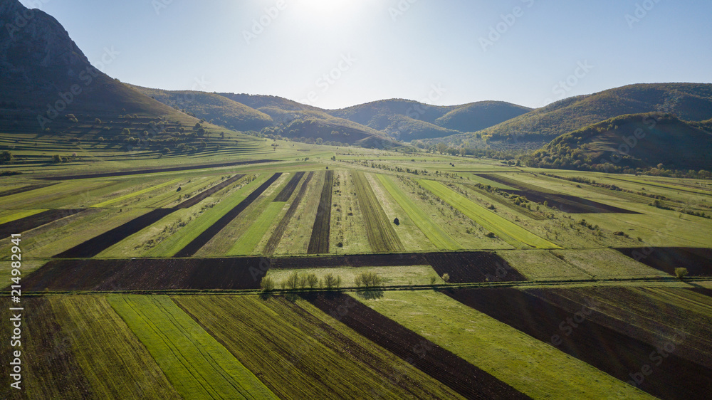 Aerial view of agricultural land during spring time in Romanian countryside.
