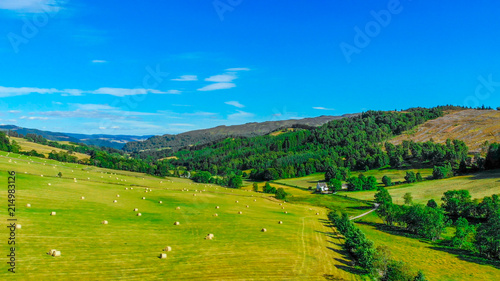 Green fields and farmland with hay bales in Scotland