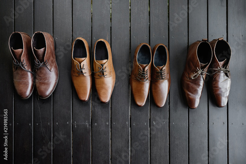Men's leather brown shoes on the black lath wooden floor