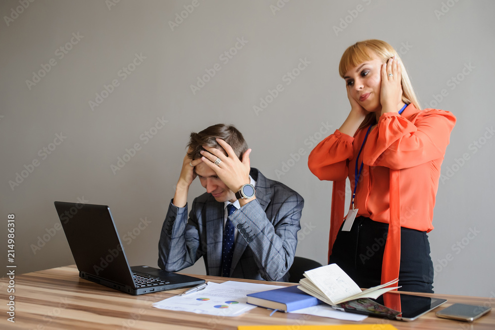 A business woman and man at a office desk looking at the project A business woman and man at a office desk looking at the project