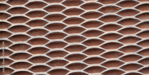 Metal solid grating with holes creating a rhythmic pattern