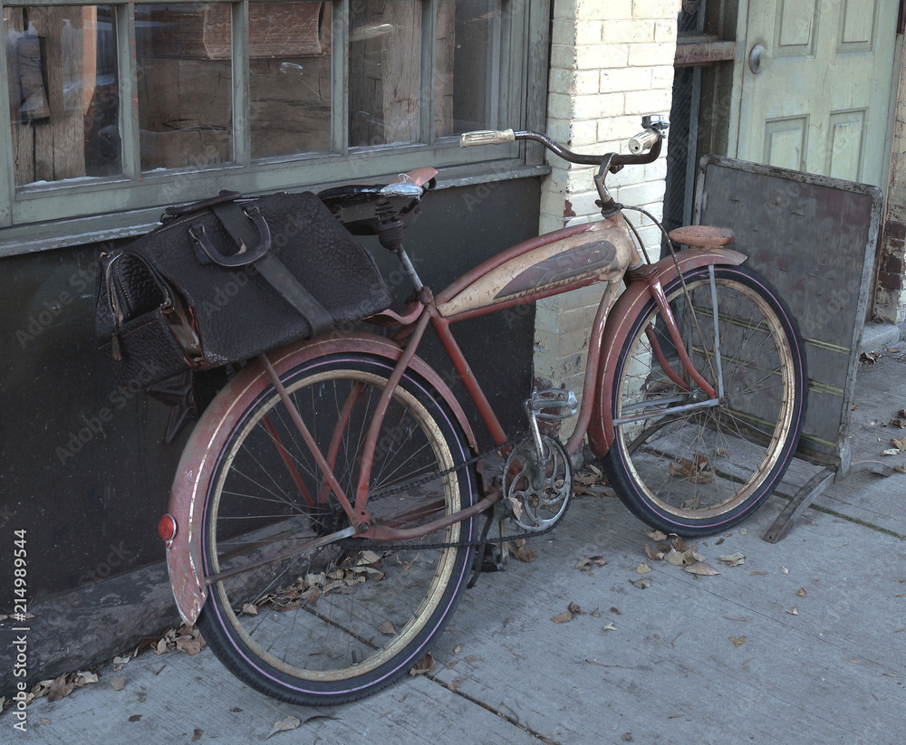 Old red bicycle with black bag