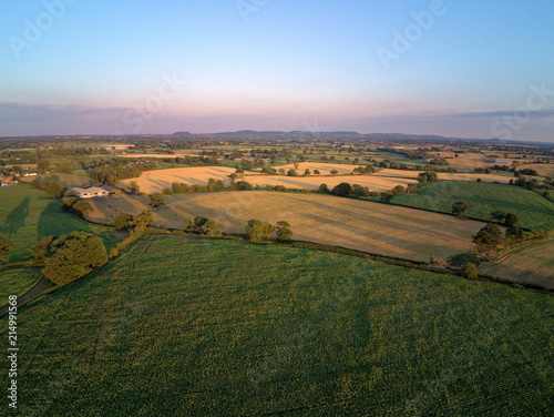 Aerial view on cheshire plains and fields. Summer pink sunset