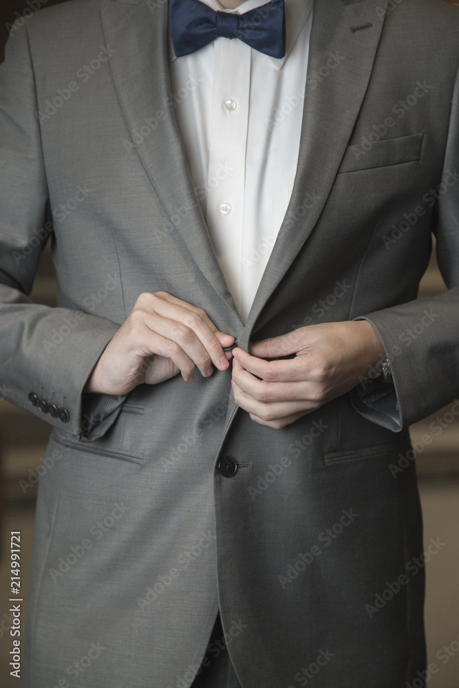 Groom Preparing for His Wedding Day in a Gray Suit