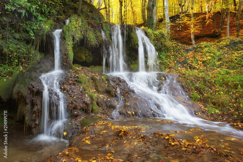 Fototapeta Naklejka Na Ścianę i Meble -  Dokuzak waterfall in Strandja mountain, Bulgaria during autumn. Beautiful view of a river with an waterfall in the forest. Magnificent autumn landscape.