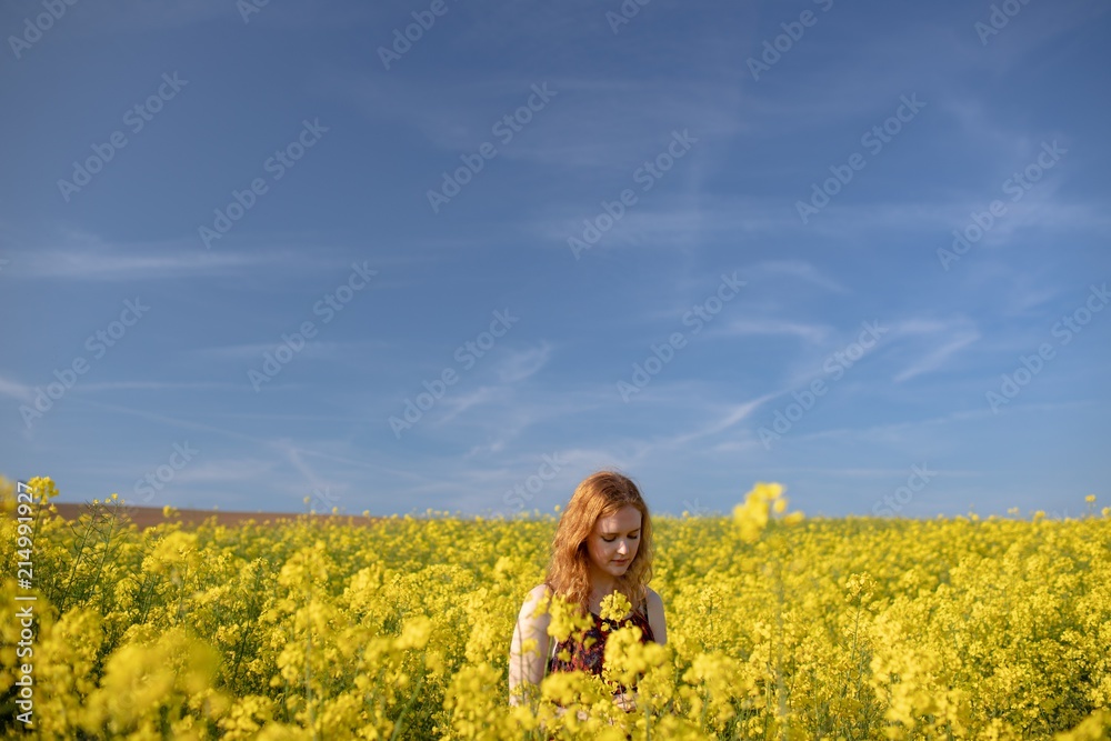 Woman touching crops in the mustard field Woman touching crops in the mustard field