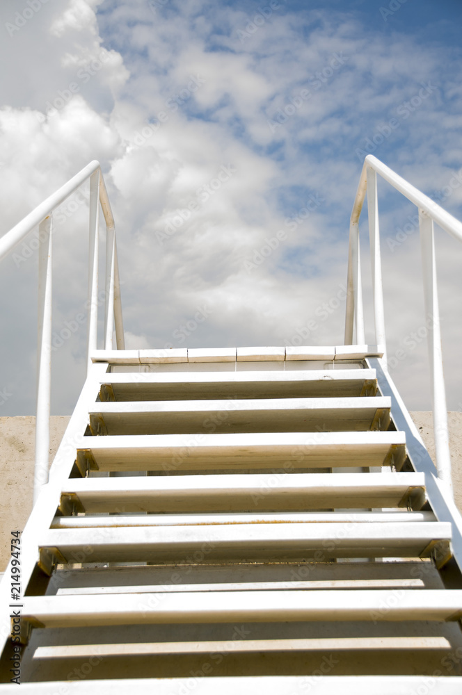 A staircase leading to the sky, skyward, a sunny day A staircase leading to the sky, skyward, a sunny day