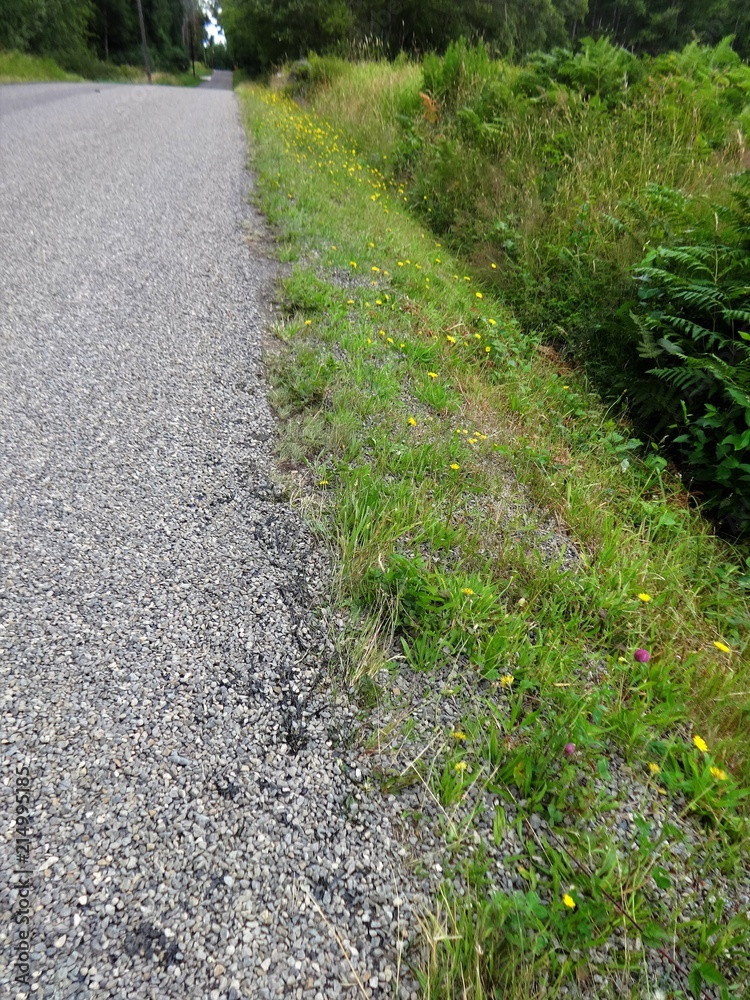 New asphalt and gravel poured on a country road New asphalt and gravel poured on a country road