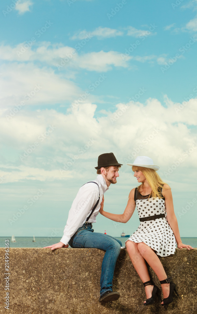Loving couple retro style dating on sea coast Loving couple retro style dating on sea coast