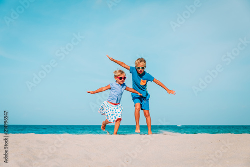 happy boy and girl run play at beach