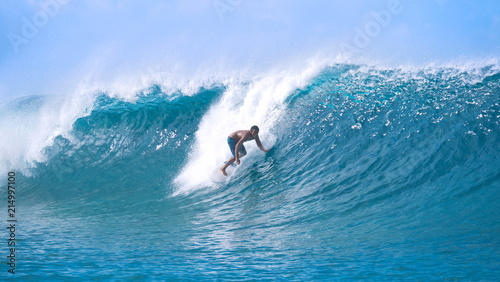 Sticker Carefree young sportsman on summer vacation surfing a breathtaking barrel wave