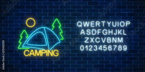 Neon camping sign with spruce and tent. Glowing web banner for camping, nature tourism with alphabet in neon style.