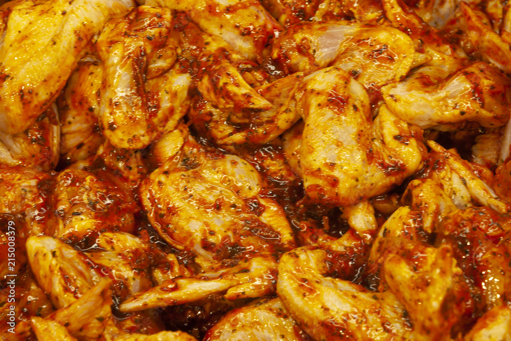 Raw chicken wings in marinade with pepper souse. Raw chicken wings in marinade with pepper souse.
