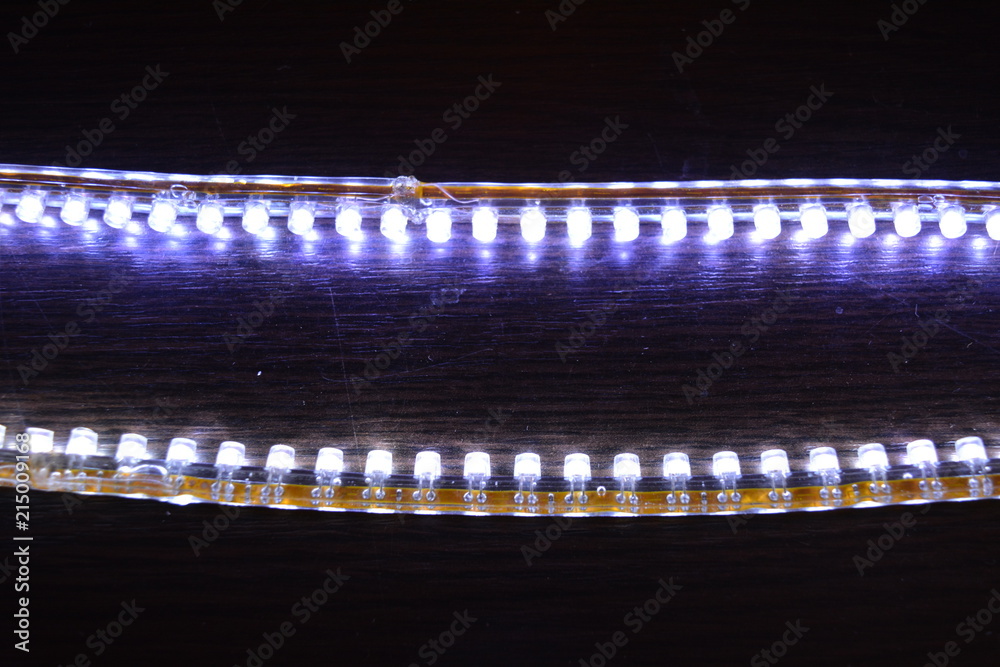 Bright glowing two LED stripes DIP in silicone included and glowing on a wooden background